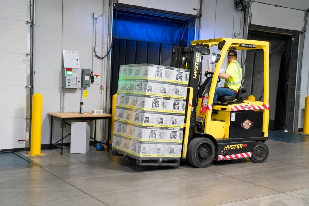 Warehouse worker operating a yellow forklift