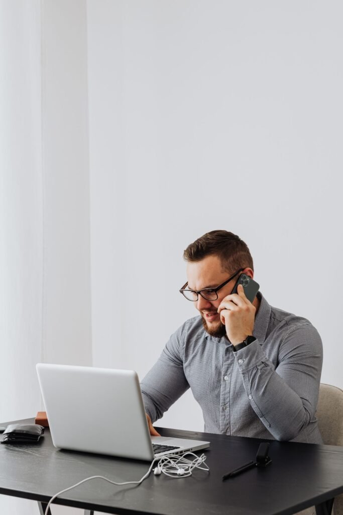 Professional working on a laptop and phone