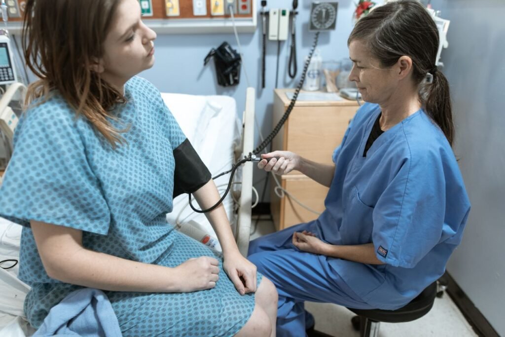 Medical assistant checking a patient's blood pressure