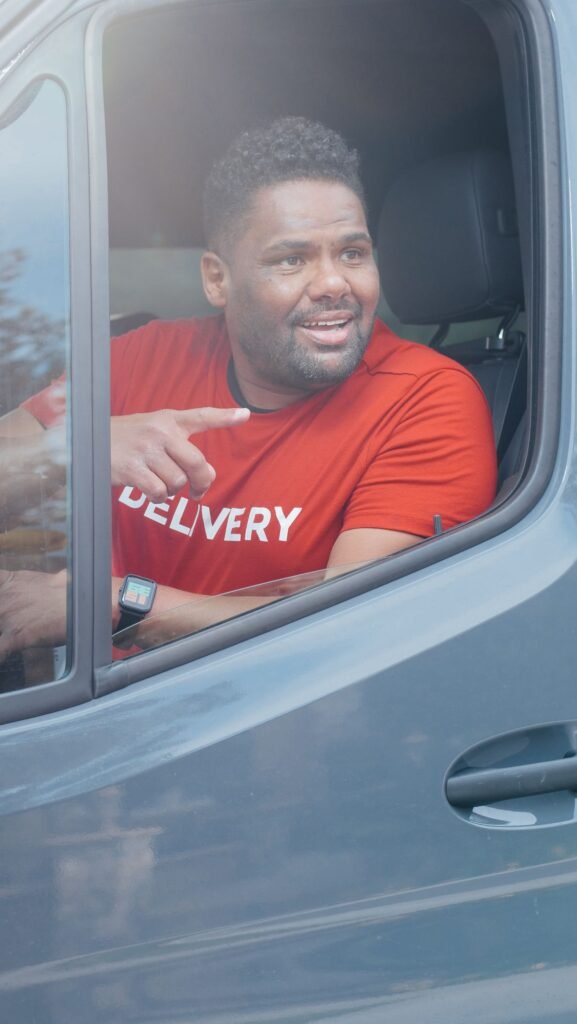 Smiling delivery driver in a van