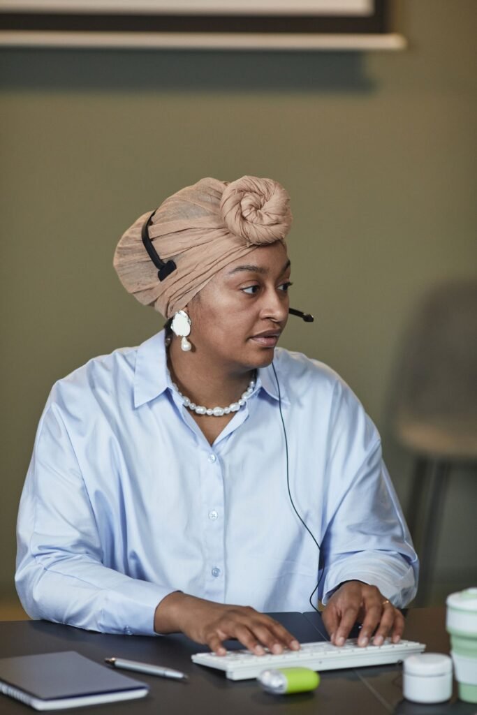 Customer service representative wearing a headset at a desk