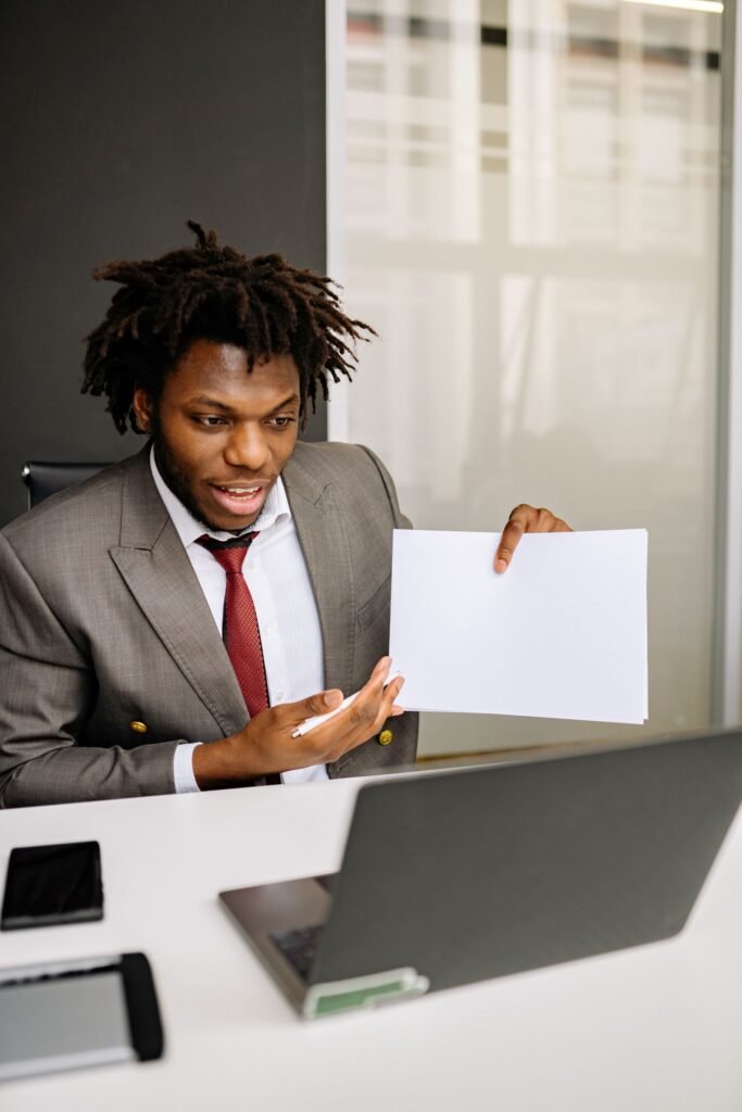 Man on a video call at his desk with documents