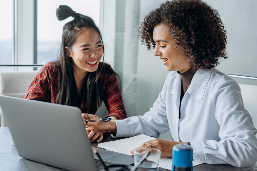 Two women collaborating at a laptop