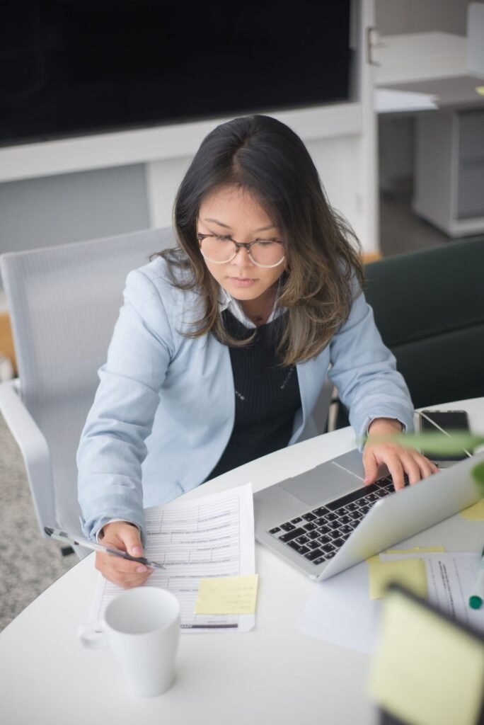Accounts payable professional working with documents and a laptop