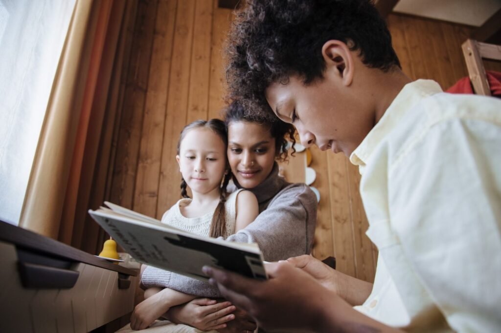 Woman reading a book with two children